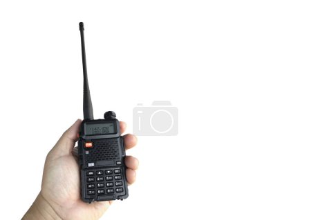 Photo for A portable radio transmitter holding in hand, blurred an outdoor building which is constructioning, soft and selective focus. - Royalty Free Image
