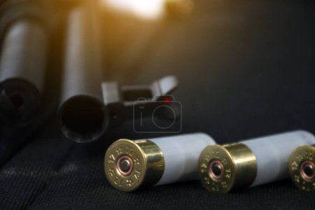 Photo for Black metal shotgun holding in hands of shooter, soft and selective focus, concept for recreational event, property, people and humans life protection concept. - Royalty Free Image