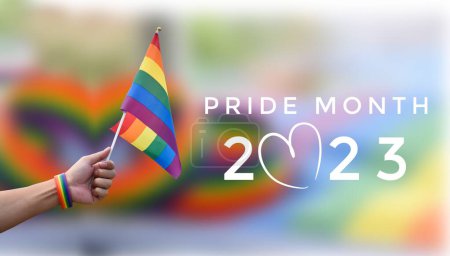 'Pride Month 2023' en el fondo borroso de la bandera del arco iris y la pulsera, concepto para las celebraciones de personas lgbtq + en el mes del orgullo, junio, en todo el mundo y llamando a la gente a respetar la diversidad de género.