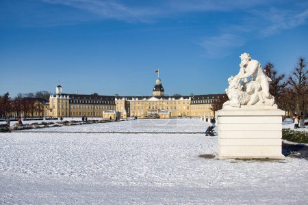 Photo for Karlsruhe, Germany - February 12, 2021: Statue on the grounds of Karlsruhe Palace under a blue sky on a cold winter day with snow on the ground in Karlsruhe, Germany. - Royalty Free Image