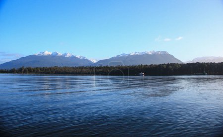 Photo for Te Anau, a small town in south island of New Zealand. A beautiful town with lake, snow mountain and blue sky. - Royalty Free Image