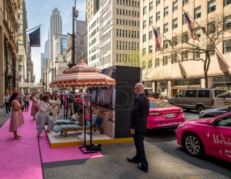 Photo for New York, NY - USA - April 14, 2023 Marvelous Mile, an event on Fifth Ave for The Marvelous Mrs. Maisel, a 60s period piece, featuring a pink carpet, Saks Fifth Avenue, and displays scenes - Royalty Free Image