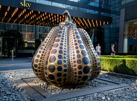 Photo for New York, NY - US - Sept 7, 2023 Horizontal view of the an iconic Pumpkin Sculpture  by renowned Japanese artistYayoi Kusama. Installed at the Sky; a single tower luxury rental development located at 605 West 42nd Street in Manhattan - Royalty Free Image