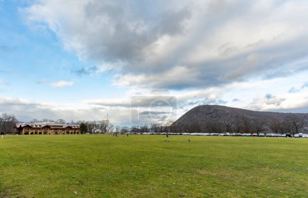 Photo for Bear Mountain, NY - US - Dec 30, 2023 Wide angle view of Bear Mountain State Parks large play field and the Bear Mountain Inn in the winter - Royalty Free Image