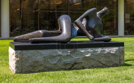Photo for Purchase, NY  US  Apr 28, 2024 Henry Moores Reclining Figure, a bronze sinuous abstracted human figure on the Donald M Kendall Sculpture Gardens at the PepsiCo World headquarters in Purchase. - Royalty Free Image