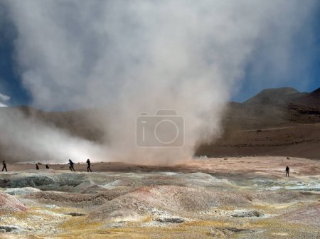 Photo for People run for cover as a sudden small twister winds its way through southern Bolivia's Sol de Manana Geysers and Geothermal area. This remote location is often visited by tourists taking an extended trek across Bolivia's Altiplano and salt flats - Royalty Free Image