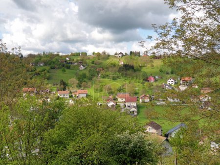 Photo for Houses on green hill - village Milanovac in Virovitica-Podravina County, Croatia - Royalty Free Image
