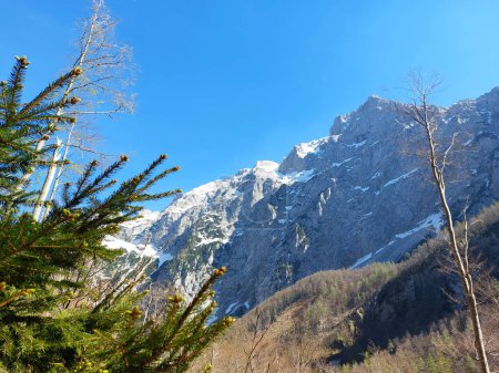 Logar valley - Kamnik Alps in Slovenia under blue sky. Snow on mountains