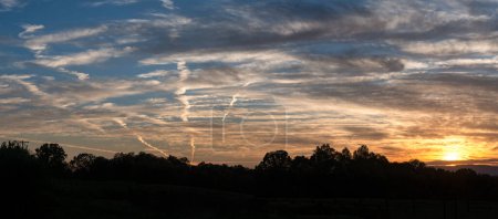 Photo for Contrails in the Sunset Sky - Royalty Free Image