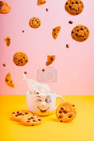 Photo for Cookies and milk in smiling cup - Royalty Free Image