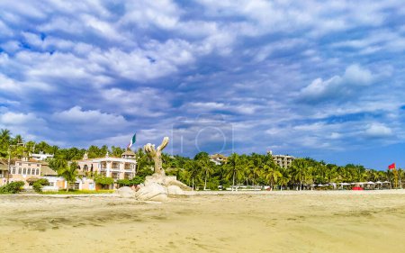 Photo for Palm trees people parasols umbrellas and sun loungers at the beach resort hotel on tropical mexican beach in Zicatela Puerto Escondido Oaxaca Mexico. - Royalty Free Image