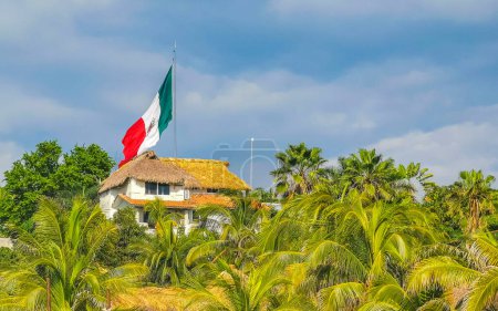 Photo for Mexican green white red flag with palm trees and blue sky and clouds in Zicatela Puerto Escondido Oaxaca Mexico. - Royalty Free Image