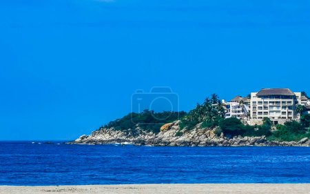 Photo for Beach sand blue water rocks cliffs and huge big surfer waves on the beach in Zicatela Puerto Escondido Oaxaca Mexico. - Royalty Free Image