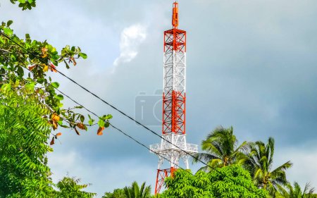 Photo for Red white 5G tower with blue sky background radiation kills us in Zicatela Puerto Escondido Oaxaca Mexico. - Royalty Free Image