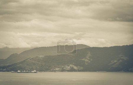 Photo for Old black and white picture of Panorama view from Abraaozinho on big tropical island Ilha Grande with drone from above to Terminal da Petrobras Angra dos Reis Brazil. - Royalty Free Image