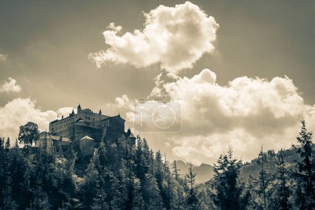 Old black and white picture of Castle Hohenwerfen chateau fortress on mountain with alpine panorama in Werfen Pongau Salzburg Austria.