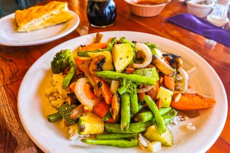 Foto de Arroz frito y verduras en plato blanco en El Cafecito en Zicatela Puerto Escondido México. - Imagen libre de derechos