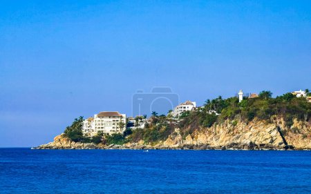 Photo for Beach sand blue water rocks cliffs and huge big surfer waves on the beach in Zicatela Puerto Escondido Oaxaca Mexico. - Royalty Free Image