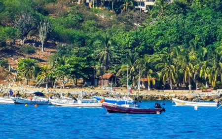 Photo for Puerto Escondido Oaxaca Mexico 16. December 2022 Fishing boats at the harbor and beach by Zicatela in Puerto Escondido Oaxaca Mexico. - Royalty Free Image