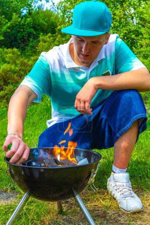 Photo for Preparing Barbeque BBQ Campfire and burning wood with orange flames in Wiefelstede Ammerland Lower Saxony Germany. - Royalty Free Image