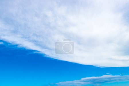 Photo for Blue sky with chemical cumulus clouds chemical sky scalar waves and chemtrails on sunny day in Playa del Carmen Mexico. - Royalty Free Image