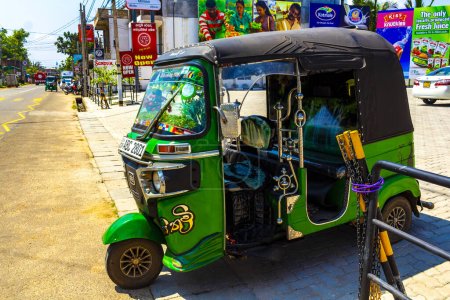 Photo for Mirissa Beach Southern Province Sri Lanka 20. March 2018 Green decorated and beautifully adorned Tuk Tuk Rickshaw in Mirissa Beach Southern Province Sri Lanka. - Royalty Free Image
