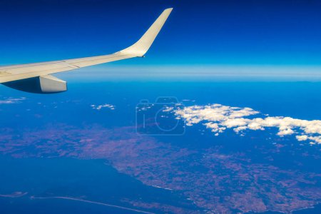 Photo for Flying by plane over Mexico with view of volcanoes mountains and clouds. - Royalty Free Image