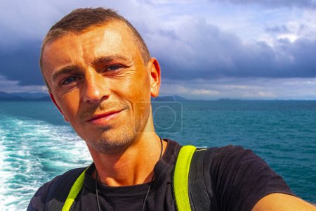 Photo for Man male handsome tourist on a ferry to Ao Nang in Ratsada Amphoe Mueang Phuket on Phuket island Thailand in Southeastasia Asia. - Royalty Free Image