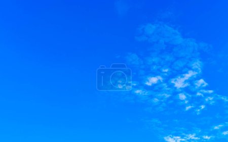 Blue sky with chemical cumulus clouds chemical sky scalar waves and chemtrails on sunny day in Zicatela Puerto Escondido Oaxaca Mexico.
