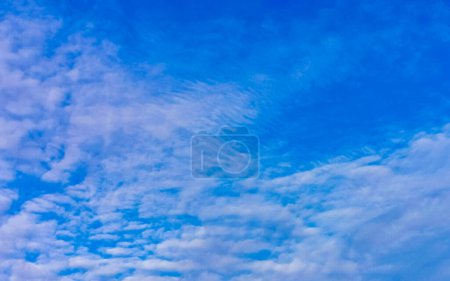 Blue sky with chemical cumulus clouds chemical sky scalar waves and chemtrails on sunny day in Zicatela Puerto Escondido Oaxaca Mexico.