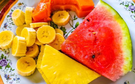 Plate with selected fruits papaya banana watermelon and pineapple in Alajuela Costa Rica in Central America.