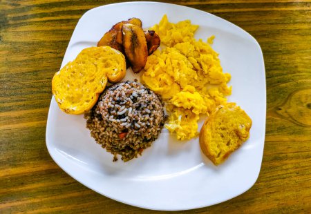 Typical Costa Rican food dish Rice Banana Scrambled eggs Beans and bread in Alajuela Costa Rica in Central America.
