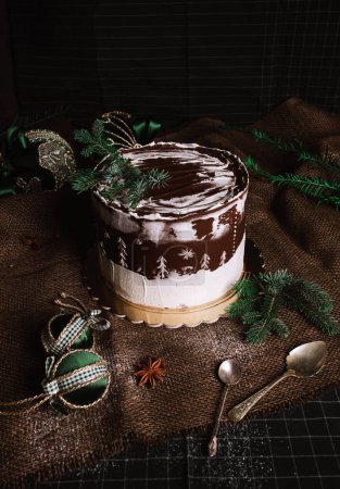 Photo for Dark food photo of glazed christmas chocolate cake with christmas decorations and balls - rustic and vintage style. - Royalty Free Image