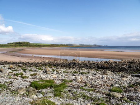 View over the beautiful sandy beach at Scalpsie Bay on the Isle of Bute, Scotland, at low tide