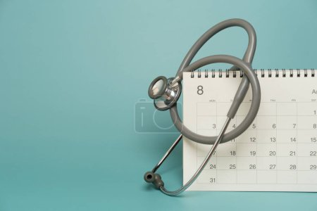 Photo for Close up of stethoscope and calendar on the green background, schedule to check up healthy concept - Royalty Free Image