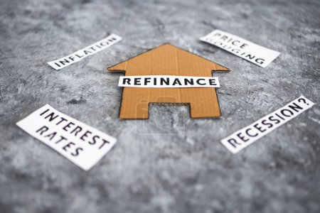 house with refinance text surrounded by concepts like interest rates inflation recession and price gouging, worldwide economic issues after the pandemic 