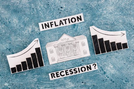 Photo for Inflation and recession texts with bank icon in between graphs with stats going up then going down, concept of economic struggles after the pandemic - Royalty Free Image