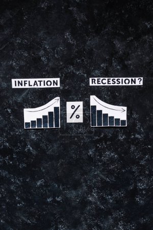 Photo for Inflation and Recession text with percentage symbol and charts showing cost of living going up  and economic growth going down, concept of post pandemic economy - Royalty Free Image