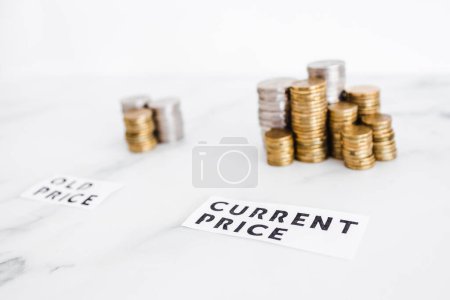 Photo for Inflation and cost of living going up concept, Old price vs Current Price with small and big stacks of coins side by side for comparison - Royalty Free Image