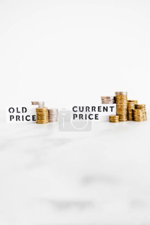Photo for Inflation and cost of living going up concept, Old price vs Current Price with small and big stacks of coins side by side for comparison - Royalty Free Image