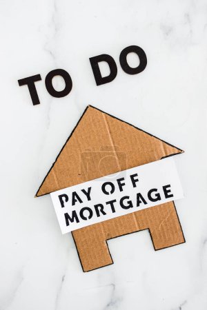 Téléchargez les photos : To Do Pay Off Mortgage text with cardboard house, concept of financial independence and being free from debt - en image libre de droit