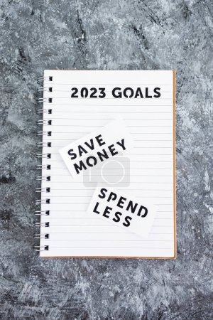 Photo for Save money and spend less on 2023 goals notebook, concept of financial stability and being free from debt - Royalty Free Image