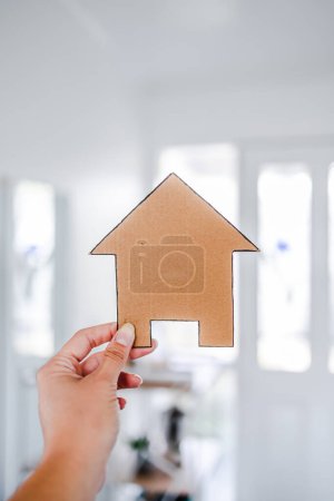 Photo for Cardboard house in front of entry door bokeh with led light, concept of finding your dream property and real estate market value - Royalty Free Image