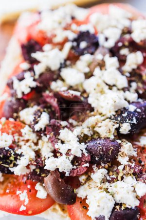 Photo for Focaccia with fresh tomatoes kalamata olives and feta sprinkled with herbs, healthy food recipes - Royalty Free Image