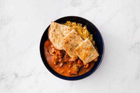 plant-based tikka masala curry with homemade naan flatbread and rice , healthy vegan food recipes