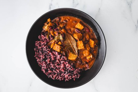 plant-based feijoada bean and tempeh stew with wild rice, healthy vegan food recipes