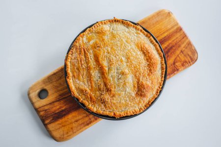 homemade round puff pastry pie in style of a sheperd's pie with sesame seeds topping just out of the oven, healthy food recipes