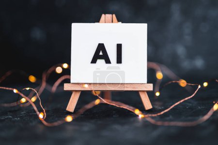 Texto AI sobre lienzo en miniatura sobre caballete sobre fondo oscuro con luces de hadas, concepto de arte y aprendizaje automático, imagen NO generada con AI