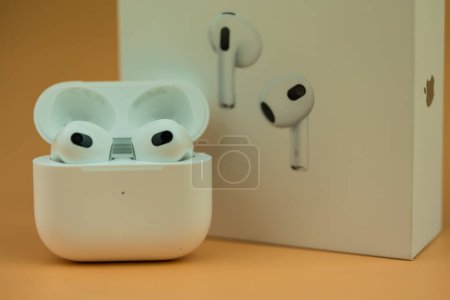 Photo for Bangkok, Thailand - November 19, 2022 : The Charging case next to New Apple Computers AirPods 3 Bluetooth headphones with Active Noise Cancellation for immersive sound - Royalty Free Image