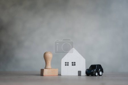 Businessman putting rubber stamp for approval loan car and home. Business real estate investment concept. Approved loan. Real estate, home and car loan concept.